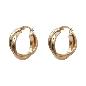 Elegant gold twisted hoop earrings with a modern minimalist jewelry design for women