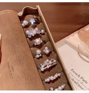 Close-up detail of elegant French style pearl rings with zircon inside a jewelry roll