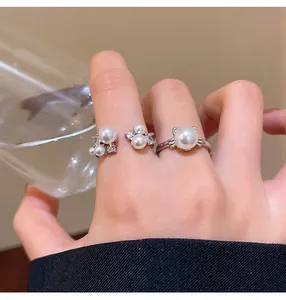 Elegant French pearl rings with unique cat-ear design worn on hand in a detailed shot