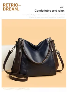 Elegant large navy blue soft leather tote handbag with brown straps and vintage hardware