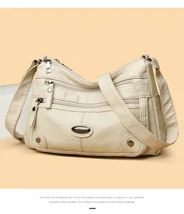 Detailed front view of a beige multi-pocket shoulder bag with premium soft leather finish