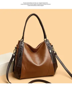 Large brown soft leather handbag featuring dual-tone design and silver hardware details.