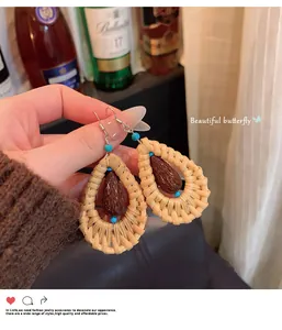 Detailed macro view of retro ethnic rattan woven teardrop earrings with turquoise beads