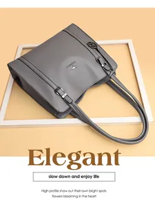 Detailed view of a grey large-capacity leather tote bag with elegant metallic logo