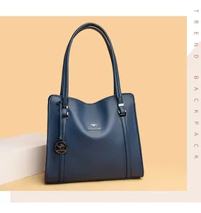 Front view of an elegant blue leather tote handbag with metallic kangaroo logo charm
