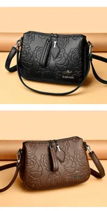 Detailed view of elegant black and brown crossbody bags with rose floral embossing.