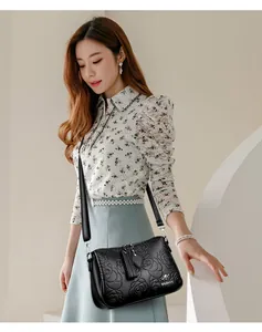 Elegant black leather crossbody bag with detailed 3D rose floral embossing