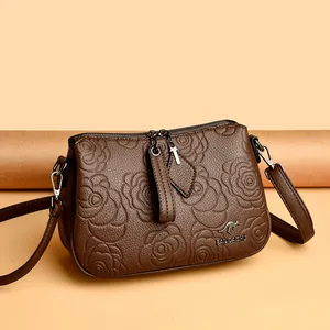 Vintage brown embossed rose crossbody bag with kangaroo logo hardware and zip closure