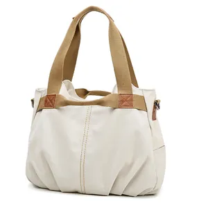 Vintage large capacity canvas tote bag with tan webbing handles and cream finish
