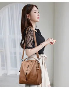 Detailed view of the stylish vintage brown leather multi-functional bag worn by a model