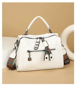 Close-up shot of this white Boston handbag featuring a stylish vintage patterned shoulder strap