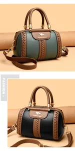 Macro view showing contrast color textures of luxury Boston style handbags in green and black.
