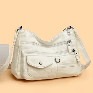 Stylish white multi-zipper crossbody bag for women with quilted detail and soft leather texture