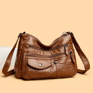 Elegant brown faux leather crossbody bag with multi-zipper pockets and embroidery