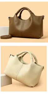 Macro detail of textured pebble leather handbags in brown and off-white with brand logo