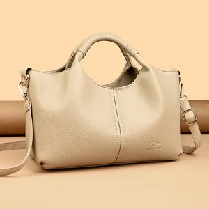 Elegant beige faux leather handbag with wrapped handle and adjustable strap for women.
