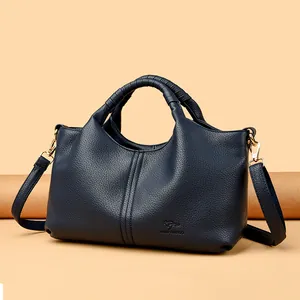 Elegant navy blue textured leather handbag for women featuring a stylish top handle