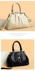 Detailansicht eleganter Ledertaschen in Schwarz und Beige mit Vintage-Metallrahmen.