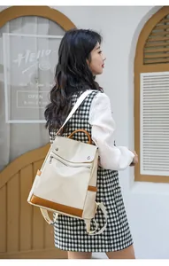 Stylish cream and tan anti-theft backpack for women in a street style lifestyle setting