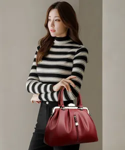 Elegante rote Lederhandtasche, getragen von einem Model mit gestreiftem Rollkragen