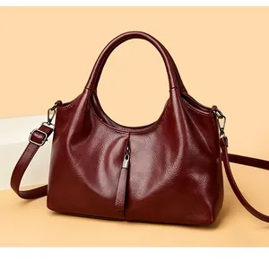 Classic wine red soft leather handbag with adjustable crossbody strap and top handle