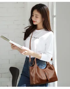 A detailed lifestyle view of the fashionable brown soft leather handbag for women