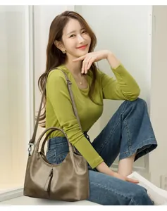 Soft leather large capacity shoulder bag shown in a lifestyle model setting