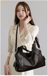 Professional model showcasing a large vintage brown leather tote bag for daily commute.