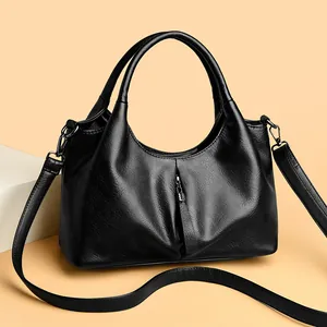 Elegant black large capacity leather handbag with crossbody strap and handle design
