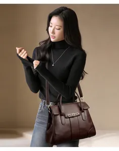 Elegant brown leather handbag for women shown with model in stylish studio setting