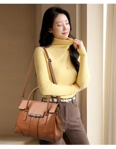 Elegant model carrying a brown vintage leather handbag with an adjustable strap