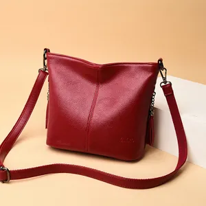 Elegant red pebbled leather crossbody bag for women with an adjustable shoulder strap