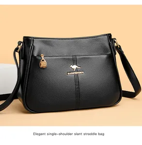 Detailansicht einer schwarzen Handtasche aus Leder mit goldenem Känguru-Markenlogo