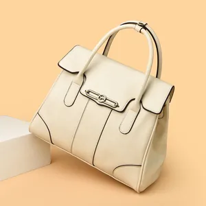 High-quality cream faux leather handbag with vintage metal hardware and large capacity.
