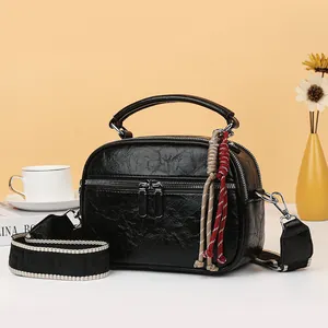 Elegante schwarze Mini-Umhängetasche aus geprägtem Leder mit gemustertem Schultergurt