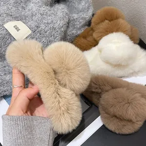 Detailed shot of soft plush faux fur hair claw clips in various neutral earth tones