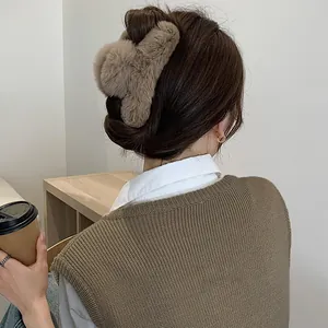 Detailed view of the plush brown faux fur hair claw clip in a bun hairstyle.