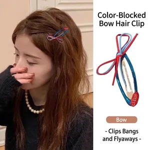 Close-up detail of a stylish contrast color bow hairpin shown on a model's hair