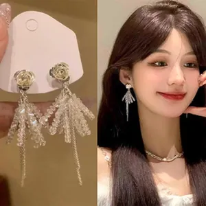 Detailed view of French petal tassel earrings with crystal beads and a model shot.