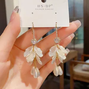 Close-up of elegant French petal earrings with pearl drops and S925 silver needles