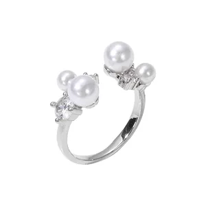 Elegant silver-toned adjustable open ring featuring white pearls and sparkling zircon.