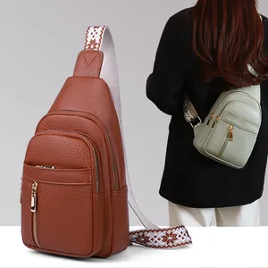 Detailed view of women's vintage chest bag with wide patterned strap and pebble texture