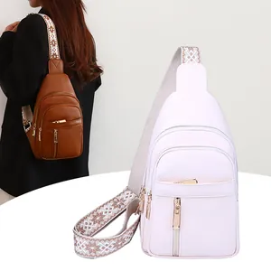 Detailed view of fashionable women's retro sling bag with a decorative wide strap