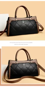Elegant black and brown quilted leather handbag with pearl details and top handle.