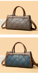 Quilted leather handbags in grey and blue with brown handles and kangaroo logo.