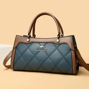 Elegant blue quilted handbag with brown handles and golden kangaroo logo emblem