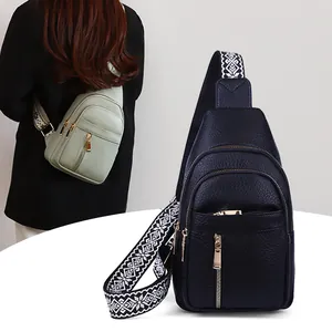 Retro crossbody chest bag for women featuring a wide geometric patterned strap and zippers