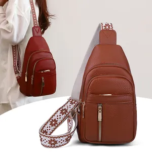 Detailed view of fashionable faux leather sling bags with wide patterned straps for women