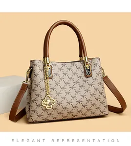 Elegant women's printed handbag featuring a gold kangaroo charm and brown handle detail