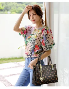 Stylish women's printed handbag with kangaroo pattern and gold-tone charm detail